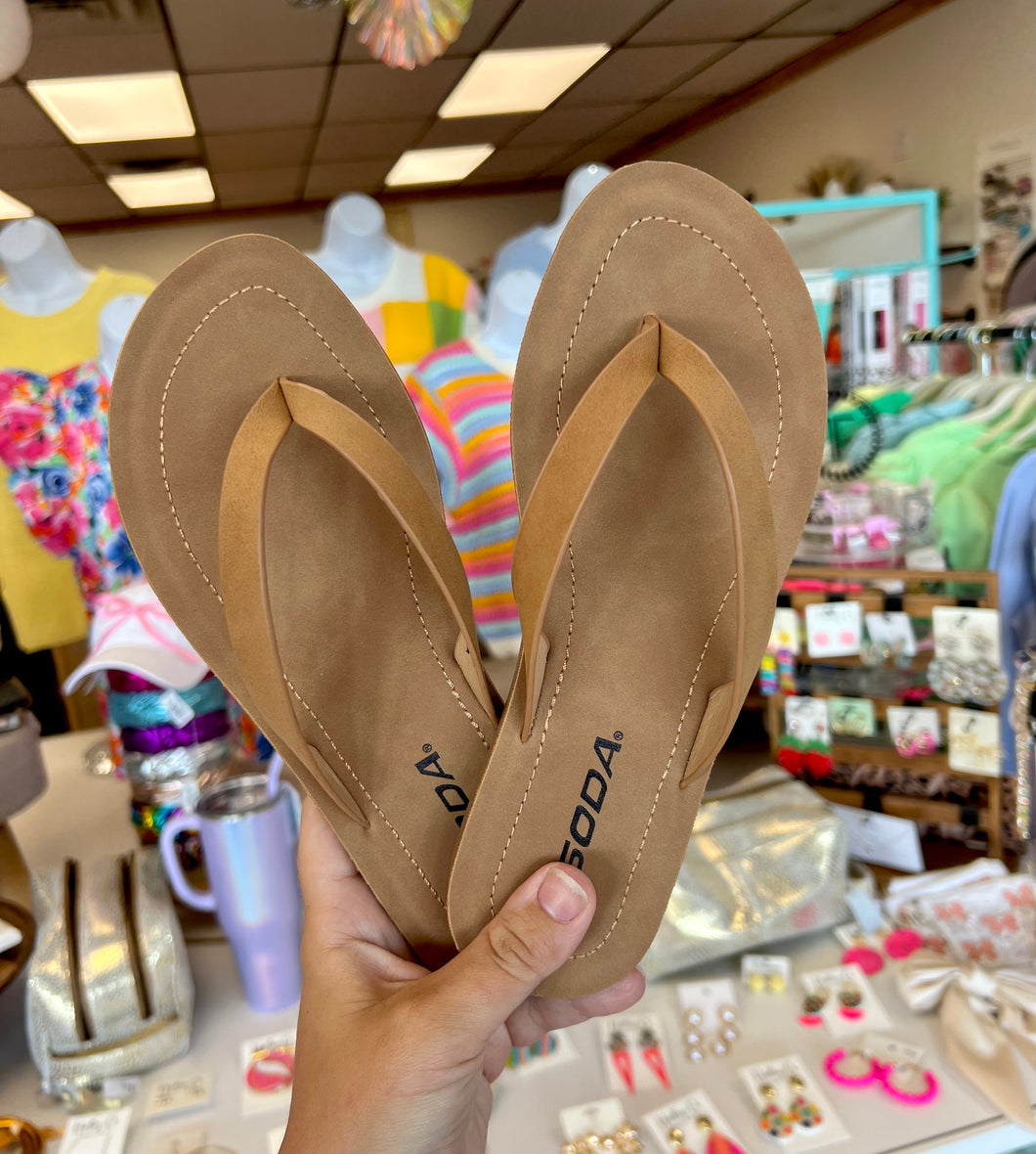 Tan flip flops