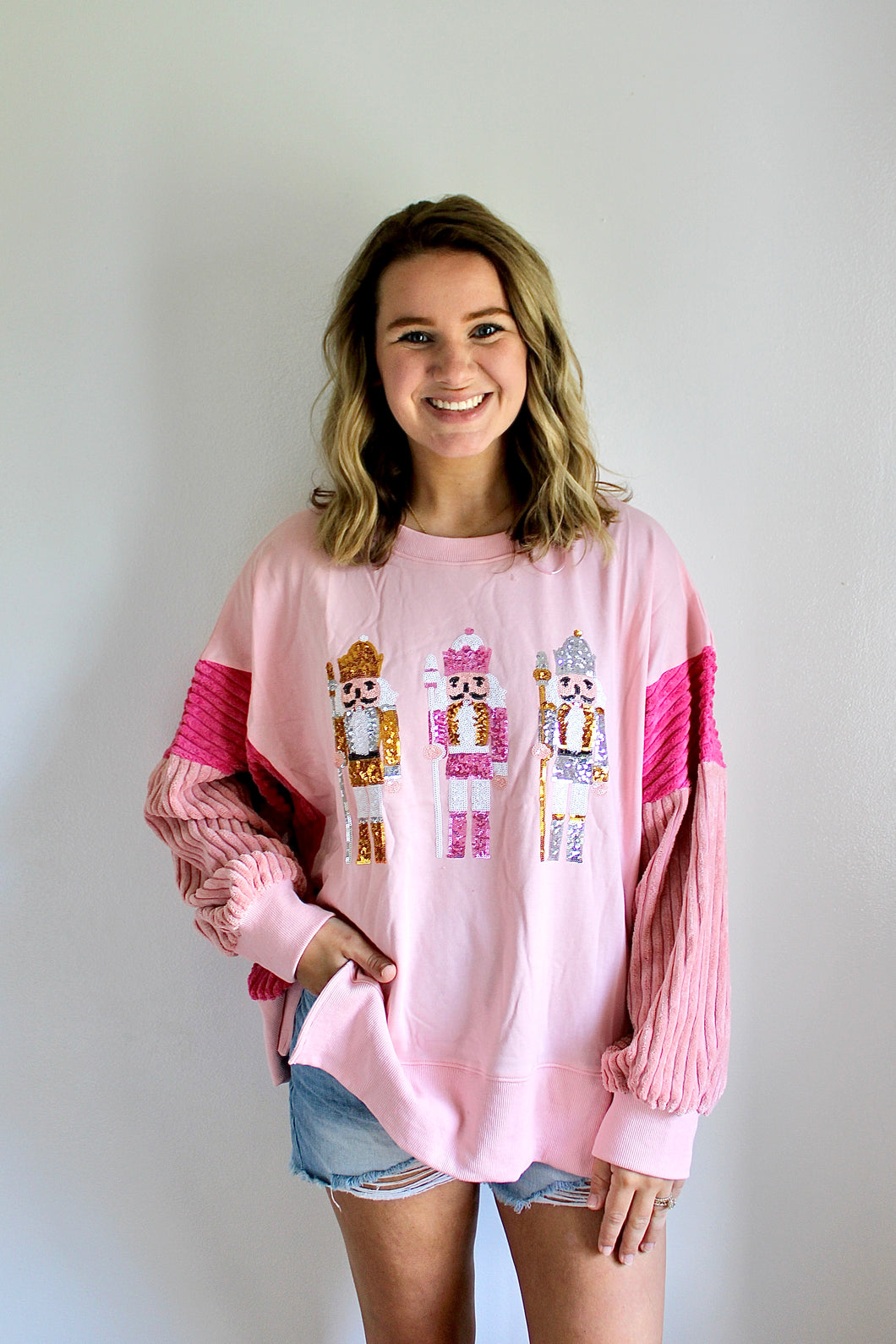 Pink sequin nutcracker pullover top