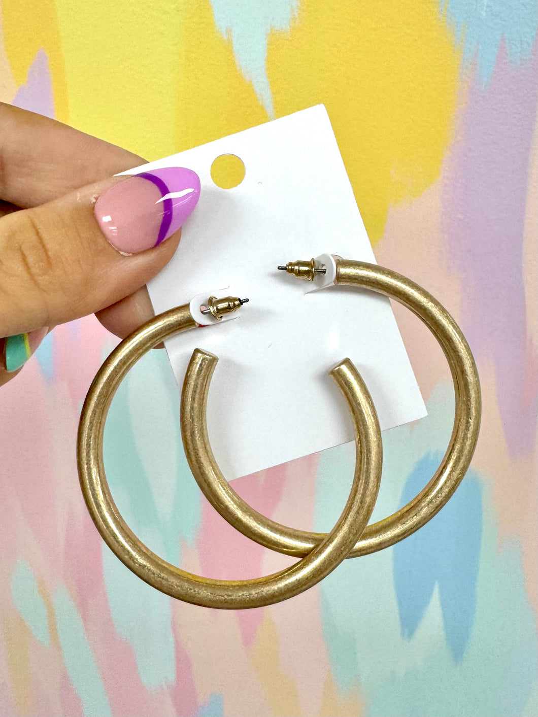 Worn gold hoops