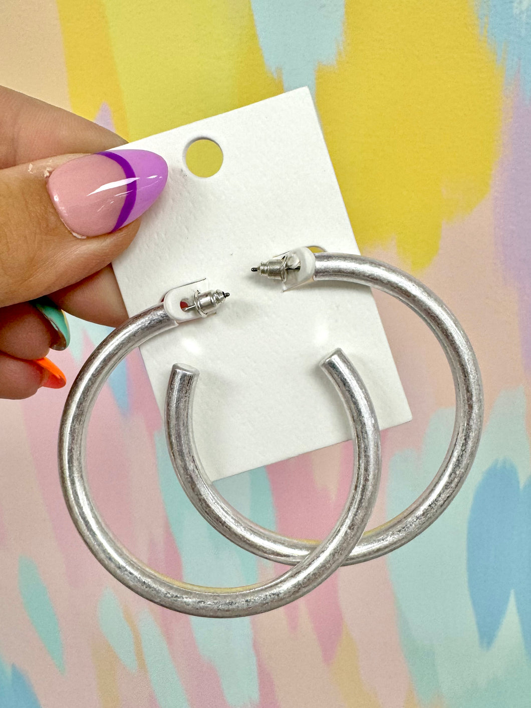 Worn silver hoops